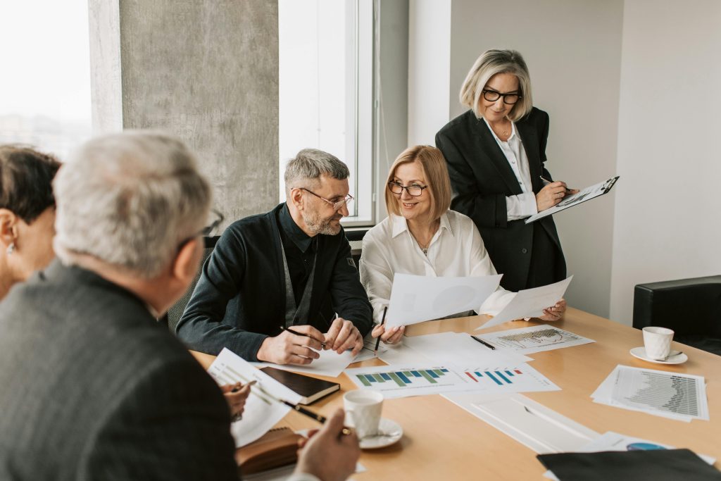 pexels-photo-7433822-7433822 A diverse group of business professionals engaged in a strategic meeting.